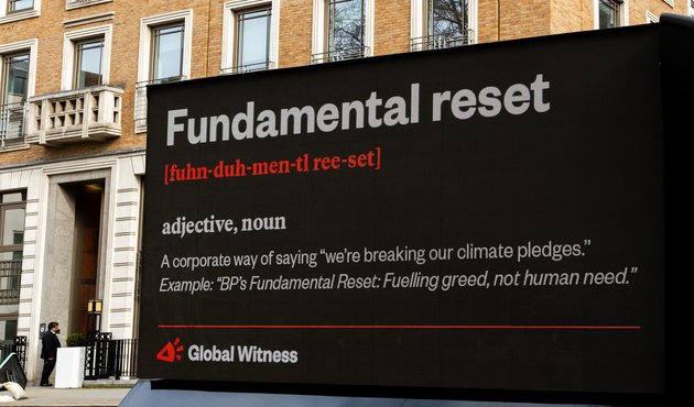 global witness billboard critiquing bp's reversal of green energy ambition